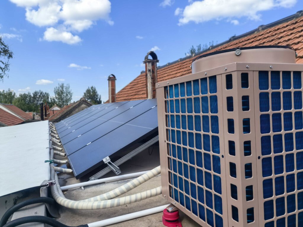 Residential PVT solar panels connected to heat pump system installed on house rooftop for hot water and heating