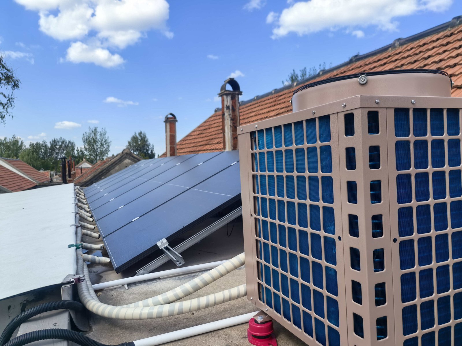 Residential PVT solar panels connected to heat pump system installed on house rooftop for hot water and heating