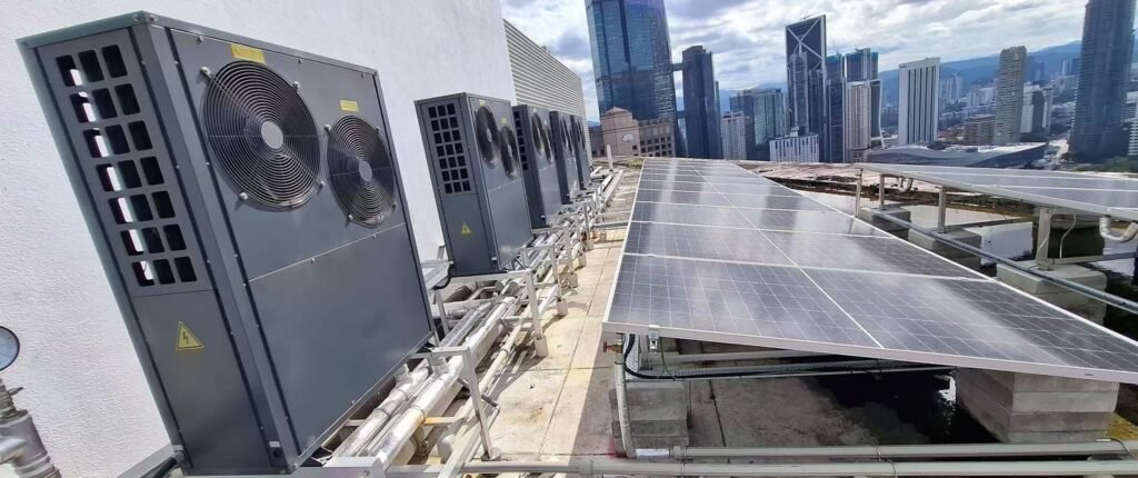 PVT solar panels with heat pump system on office building rooftop providing hot water supply