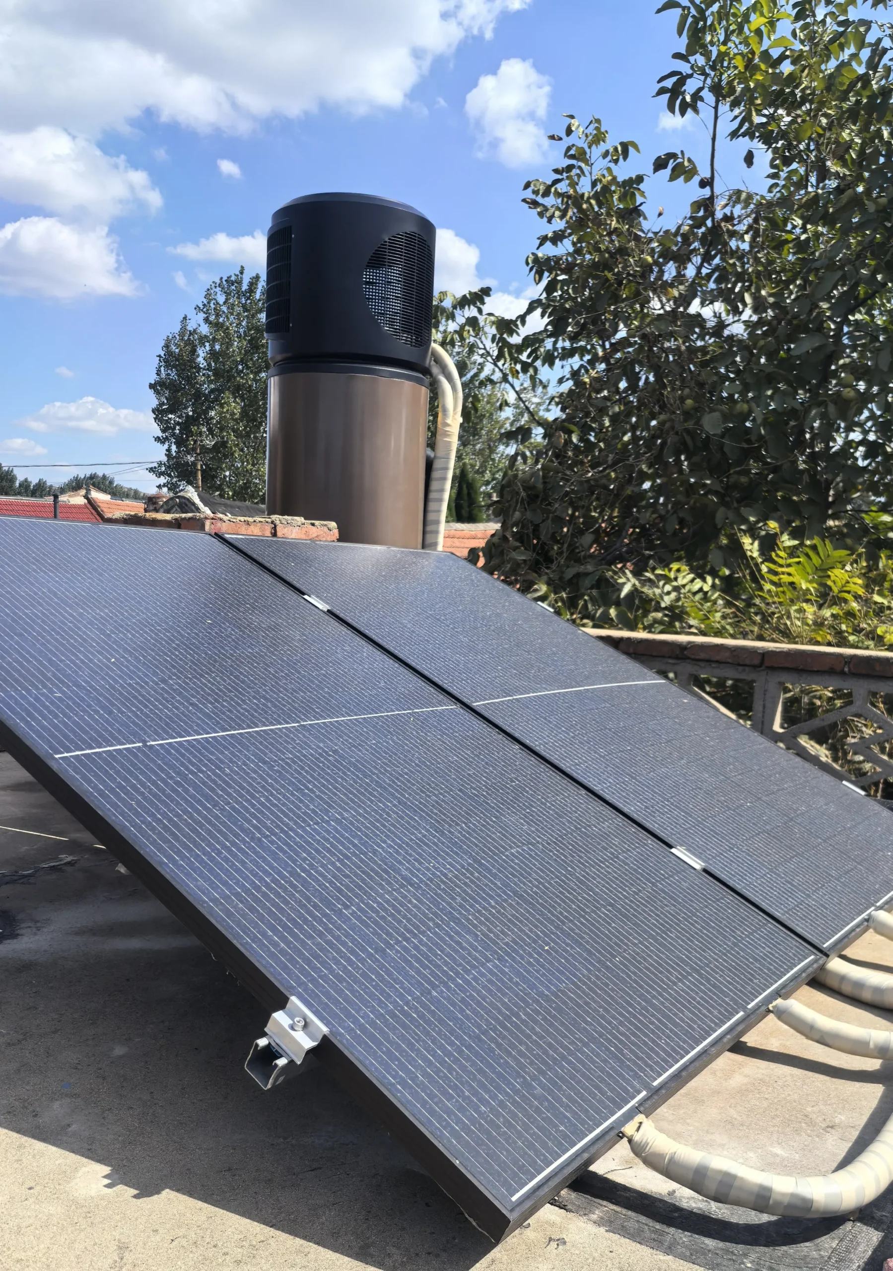 Residential brine-loop PVT collectors mounted on a rooftop, connected to a heat pump system for hot water and space heating