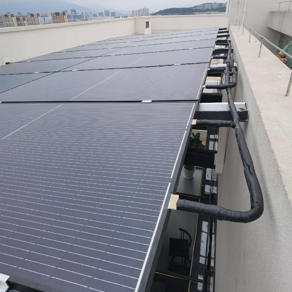 16-panel PVT collector array installed on a rooftop as a preheating retrofit for an existing air source heat pump system