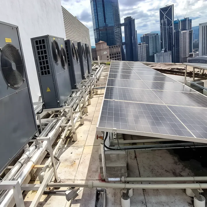 14-panel PVT collector array on a high-rise commercial building rooftop, connected to a brine-to-water heat pump system