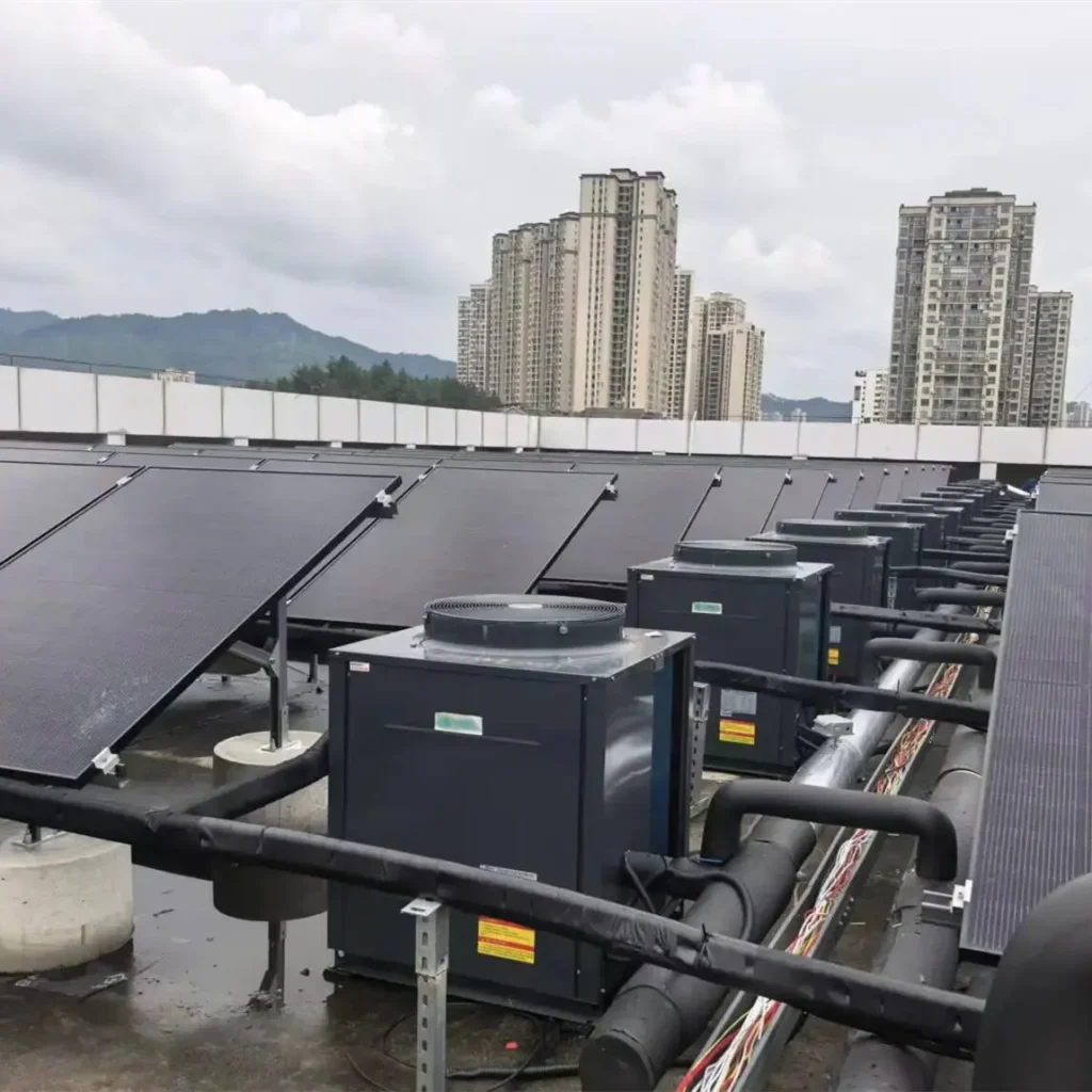 144-panel direct expansion PVT array with 12 dual-source heat pumps installed on a hotel rooftop for commercial hot water and heating